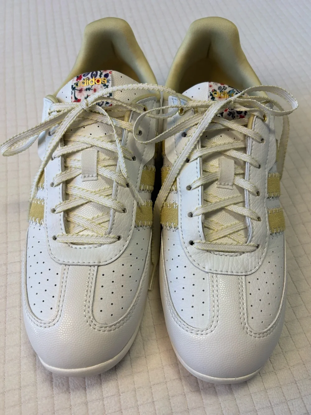 Adidas cream colored sneakers with floral accents